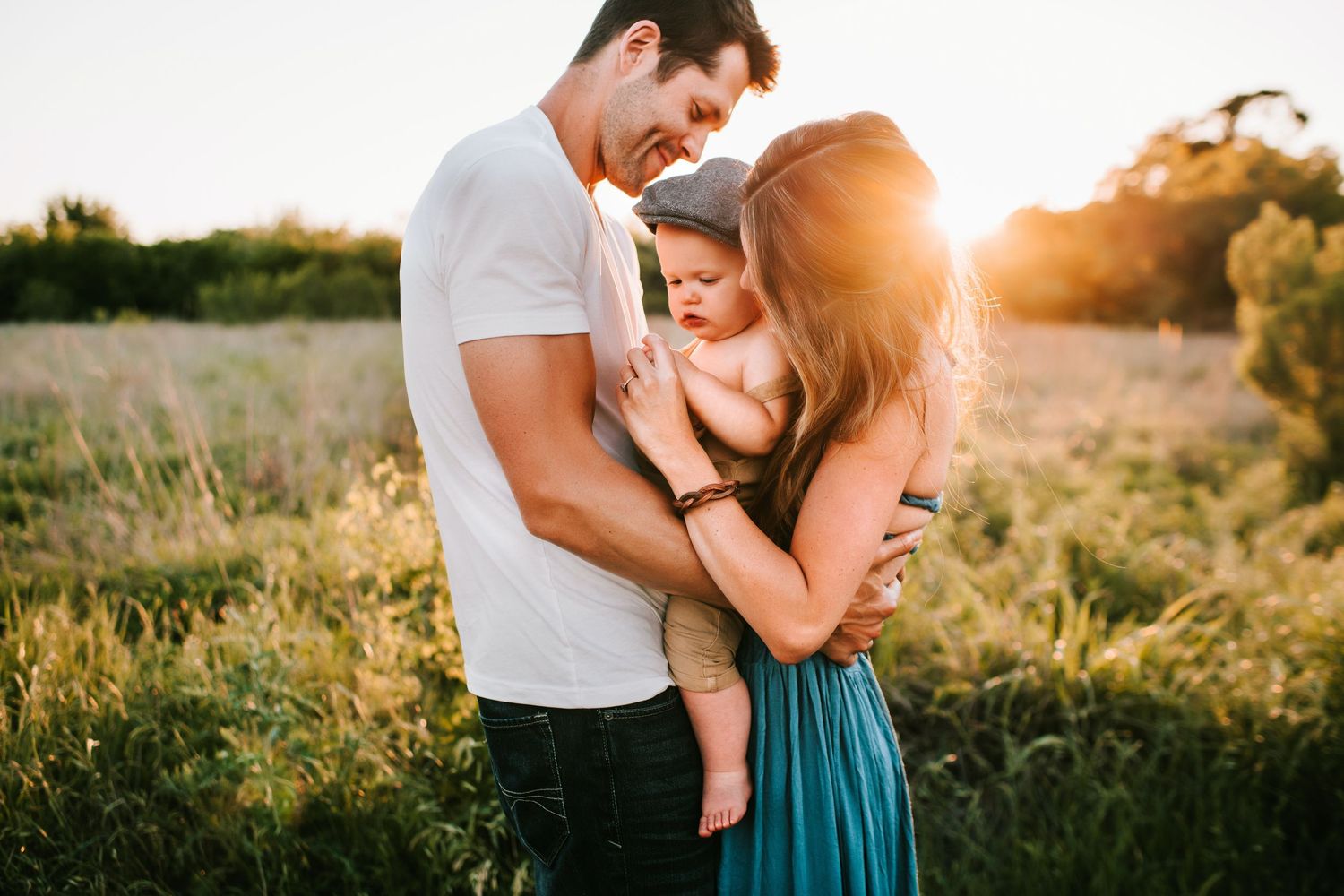 albertvphotos, family of 3 hugging each other and kissing baby forehead