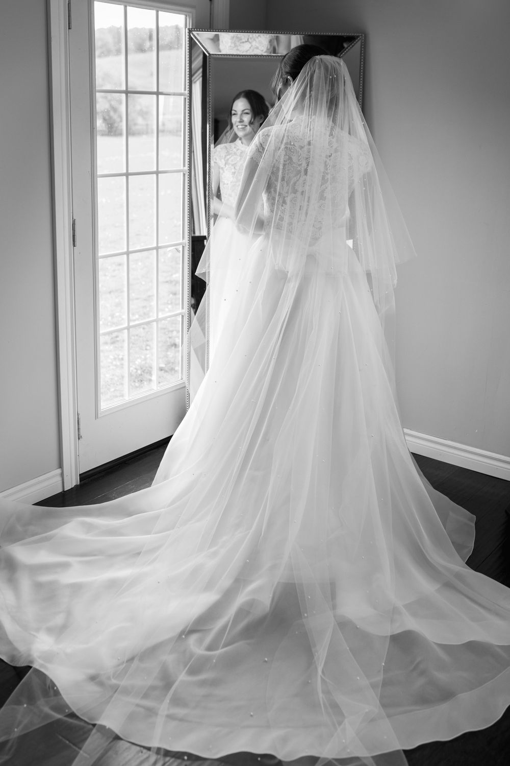 Dramatic black and white photos of a wedding dress train flowing across the floor.