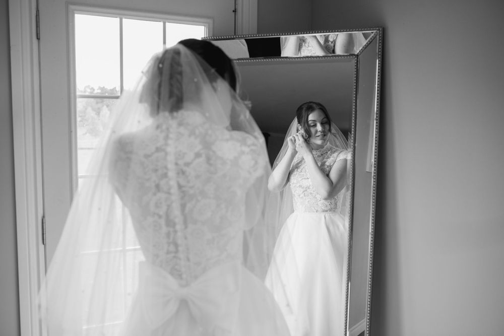 Wedding dress details captured in black and white showing intricate lace patterns.