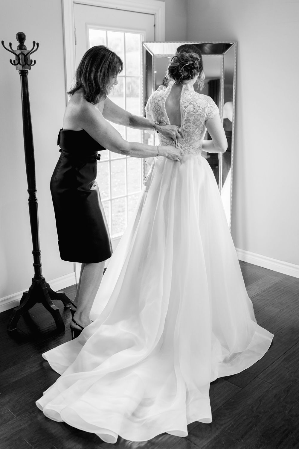 Wedding dress preparation sequence showing the final adjustments in a sunlit room.