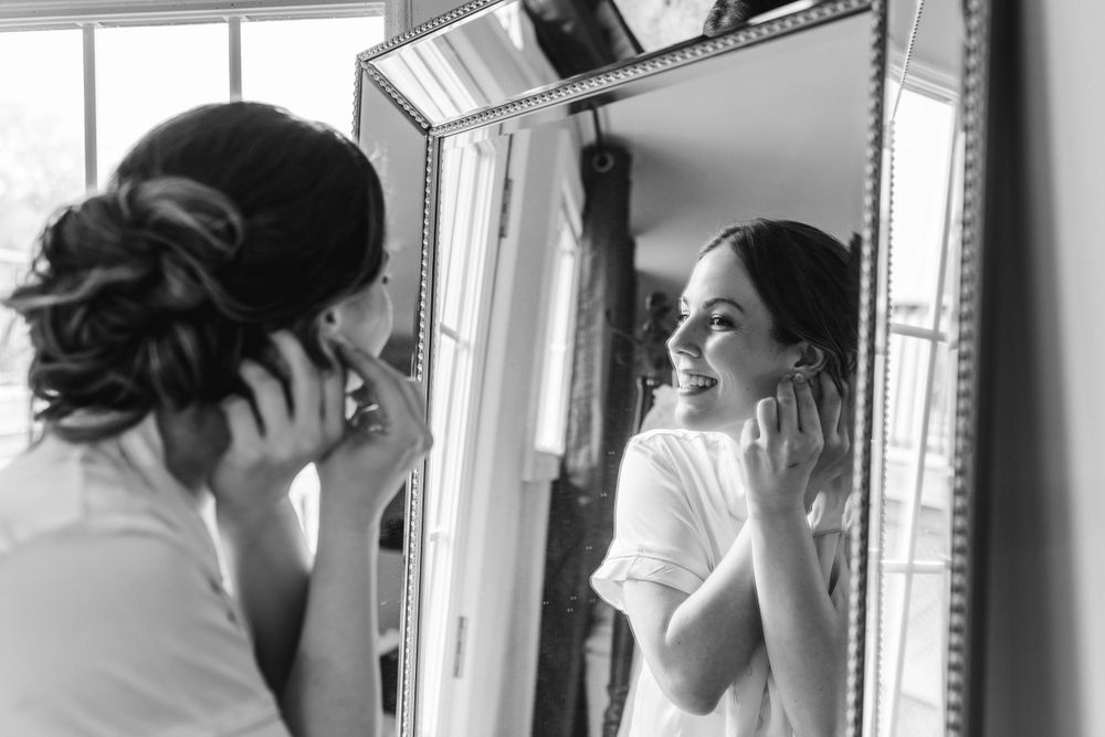 Black and white photos showing wedding day hair and makeup preparation.