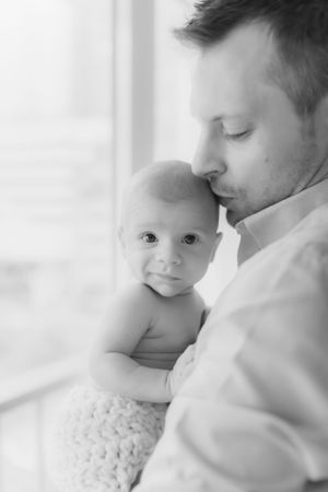 Intimate close-up family portraits in dreamy white tones.