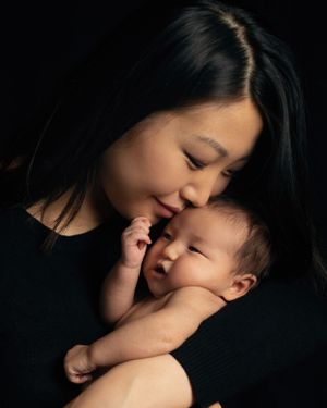 Intimate black and white portrait of mother and baby bonding moment.