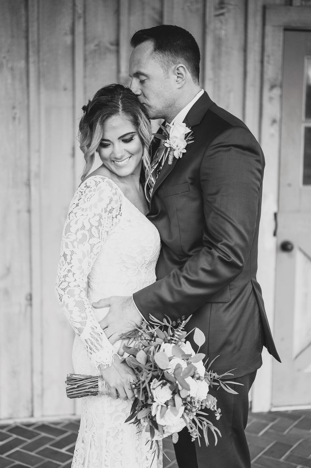 groom kissing bride on head portrait at Edel Haus alpaca farm