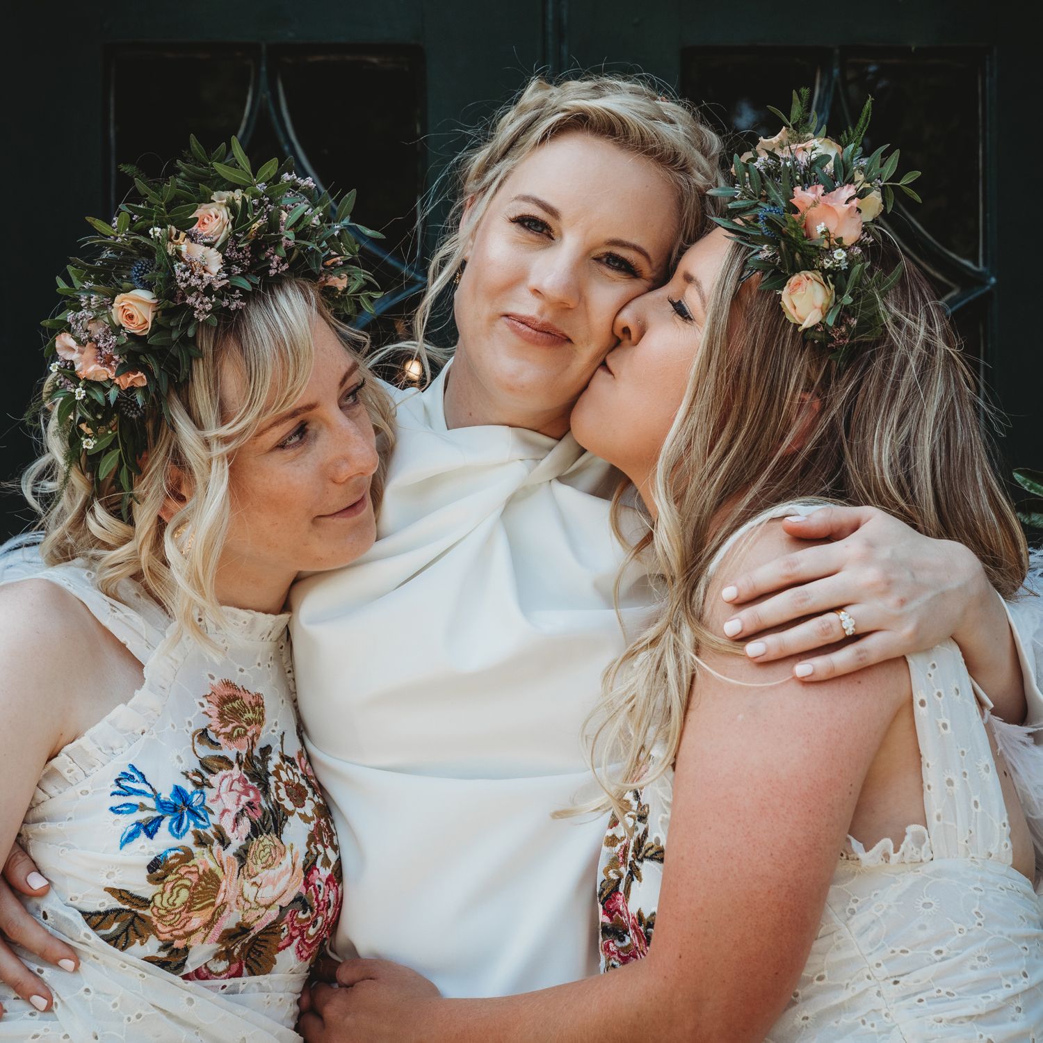 Bride hugging her bridesmaids on her wedding day, Clissold House, Stoke Newington, Hackney.