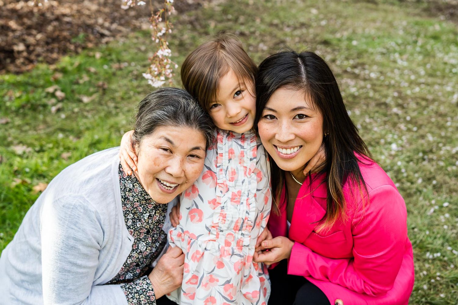 Three generations of women pose for a portrait