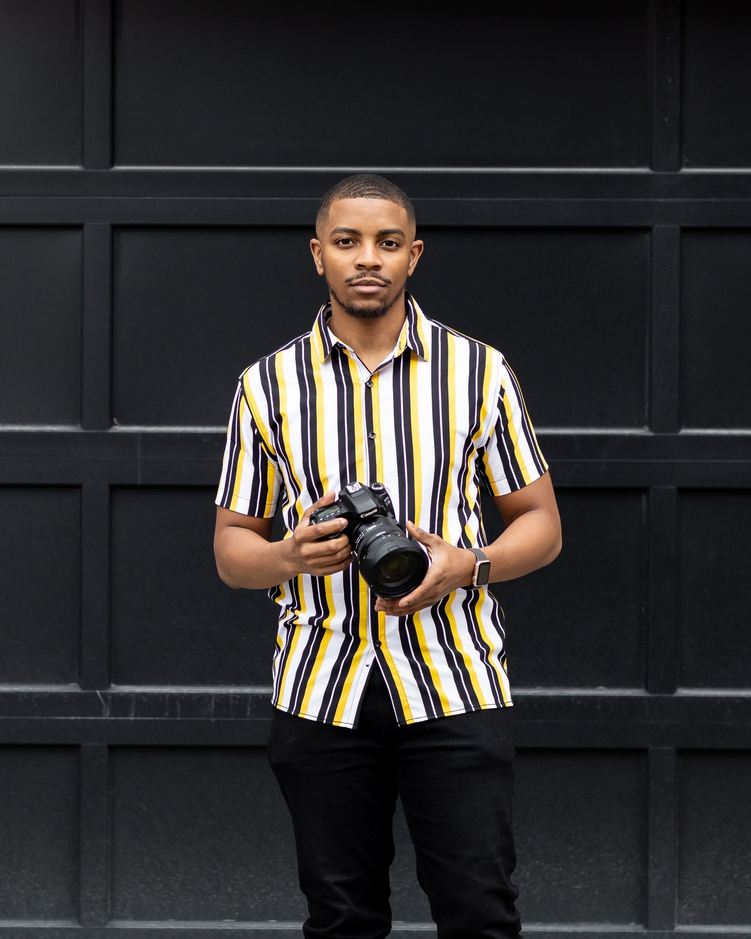 Raymond Carrington Holding Camera