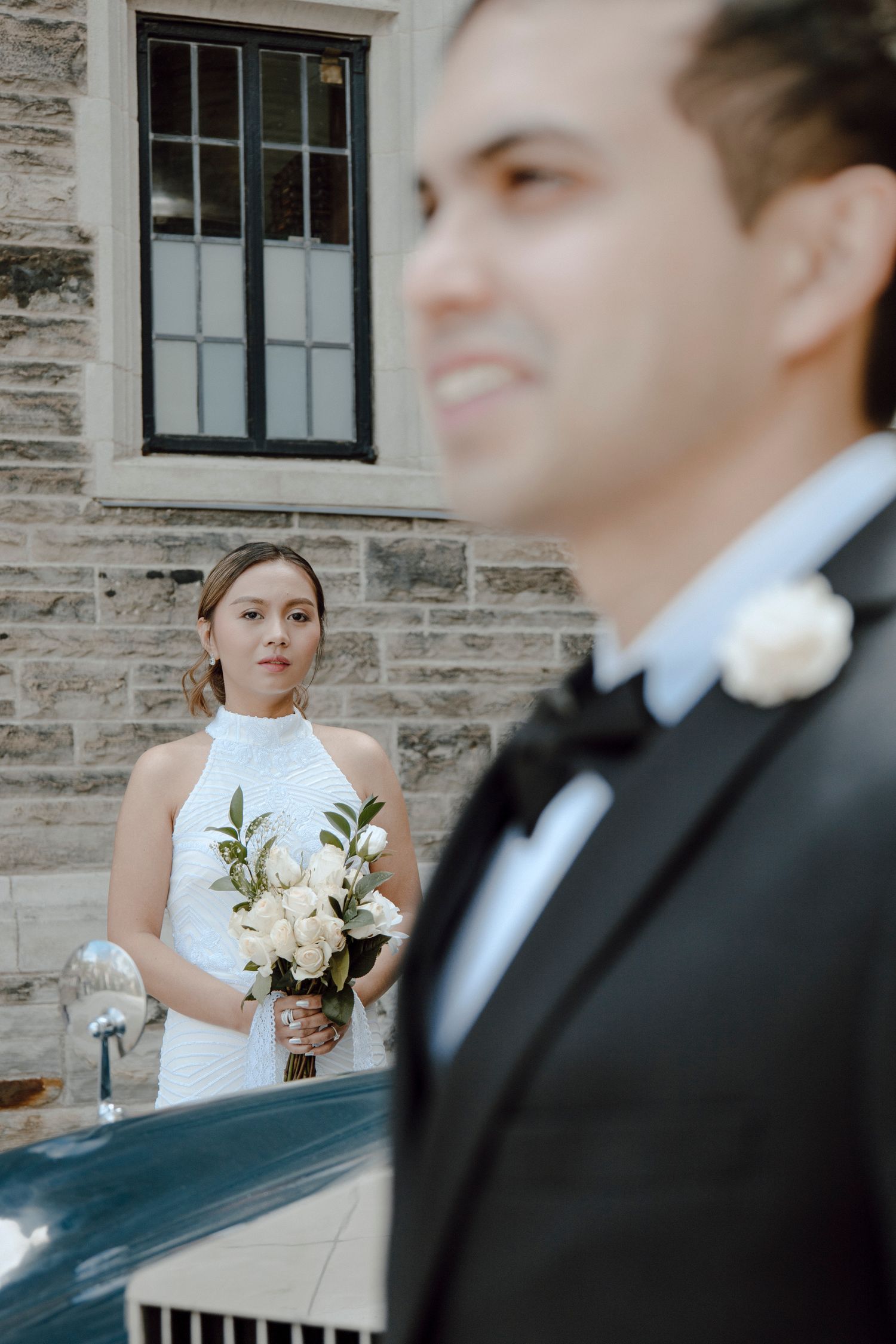 Bride looks at Groom while Groom is looking somewhere