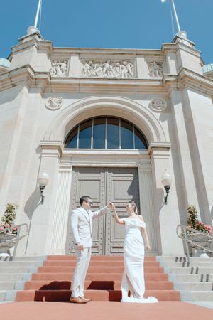 Groom spinning Bride in front of church