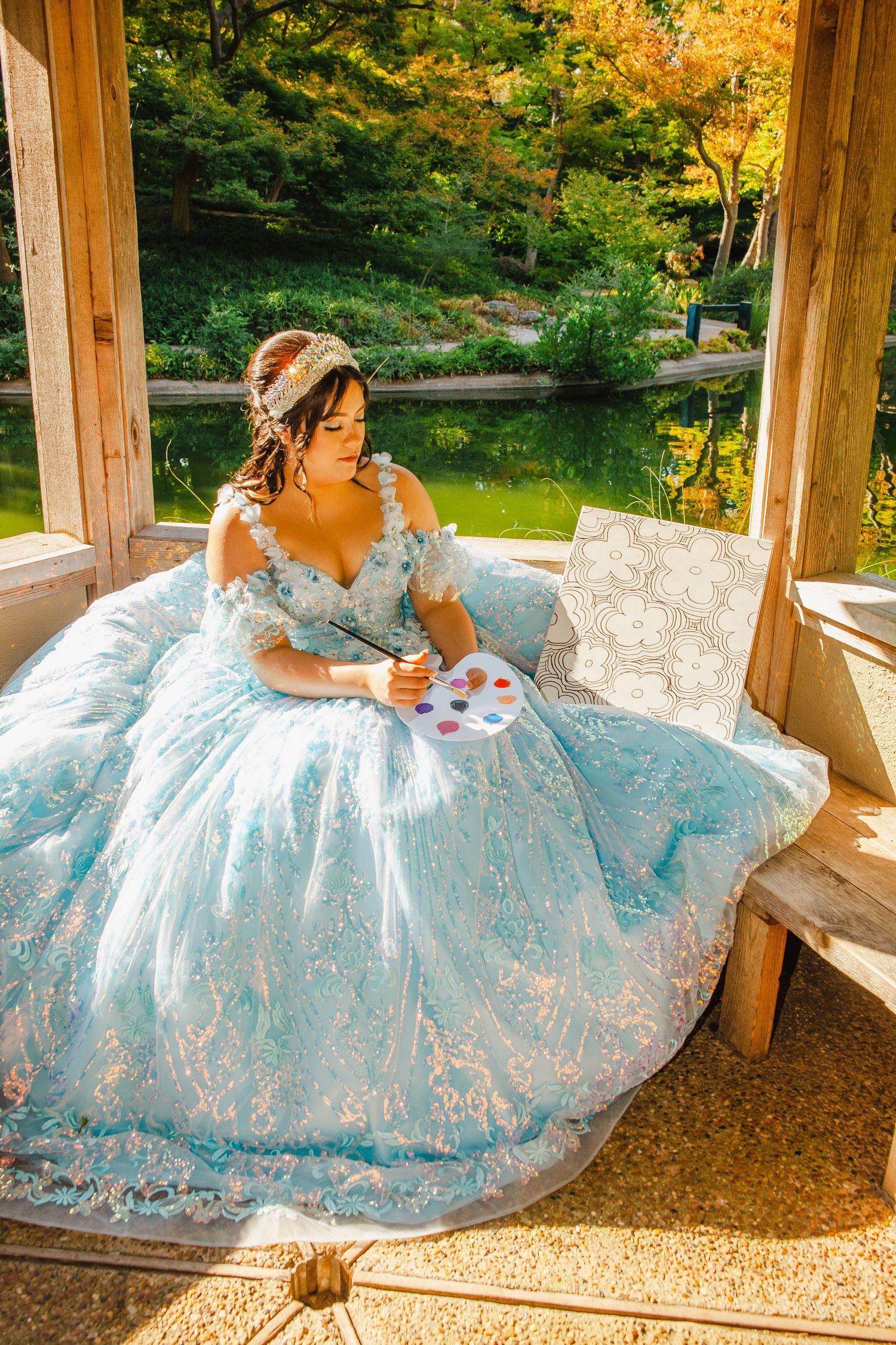 Light blue embellished ballgown photographed in rustic gazebo setting with pond view.