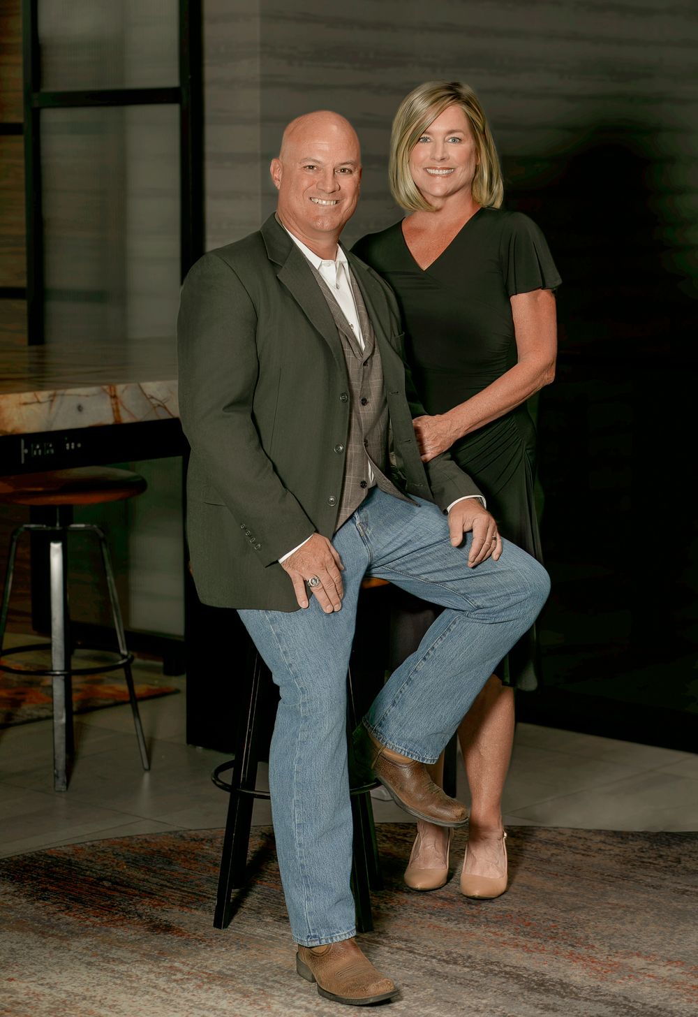 A series of poses showing a couple in formal and casual attire interacting in dimly lit setting.