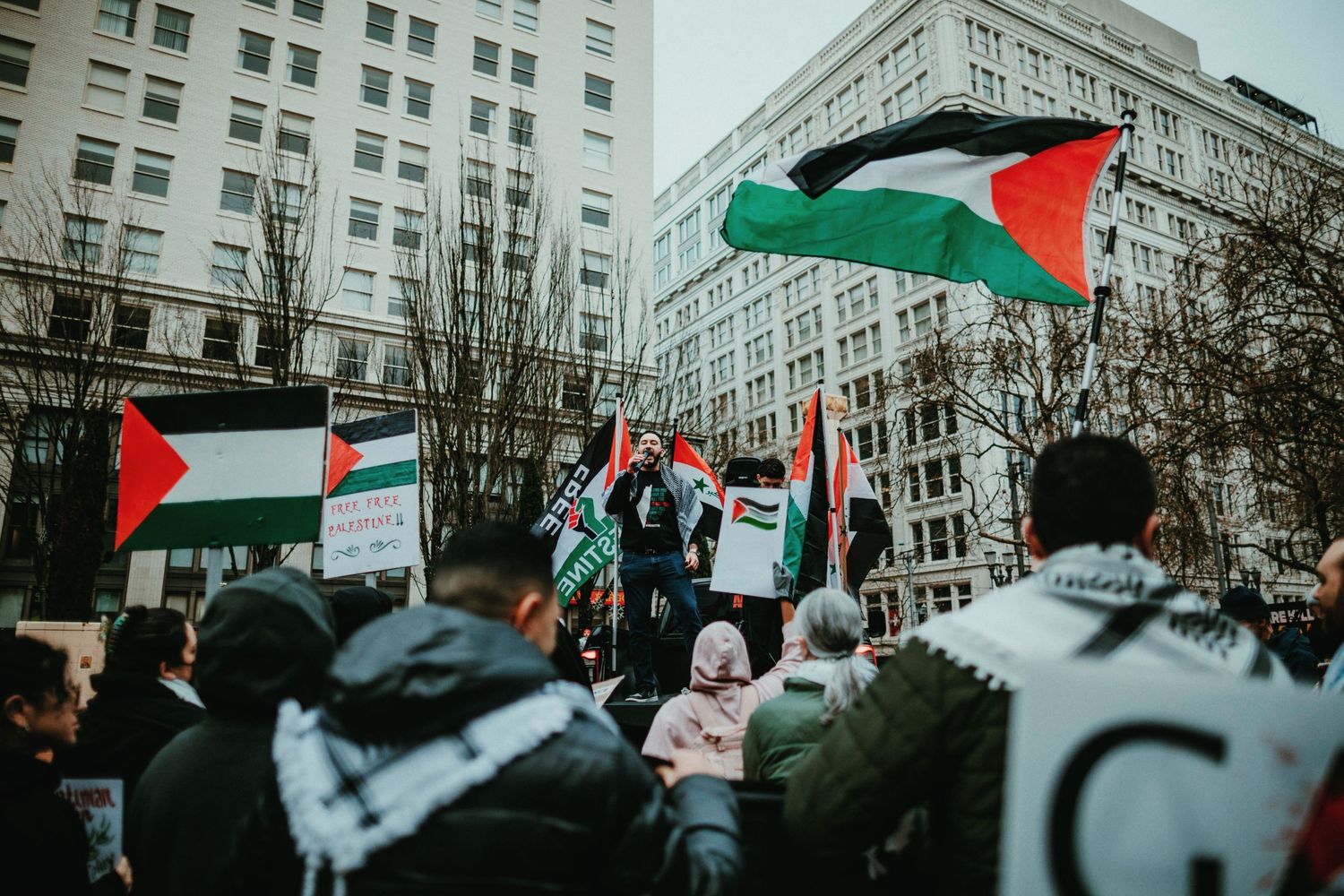 Palestinian organizer speaks to crowd at Pioneer Square in Portland oregon photojournalism