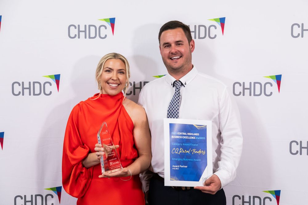 Award winners pose with trophies against a white backdrop with CHDC logos.