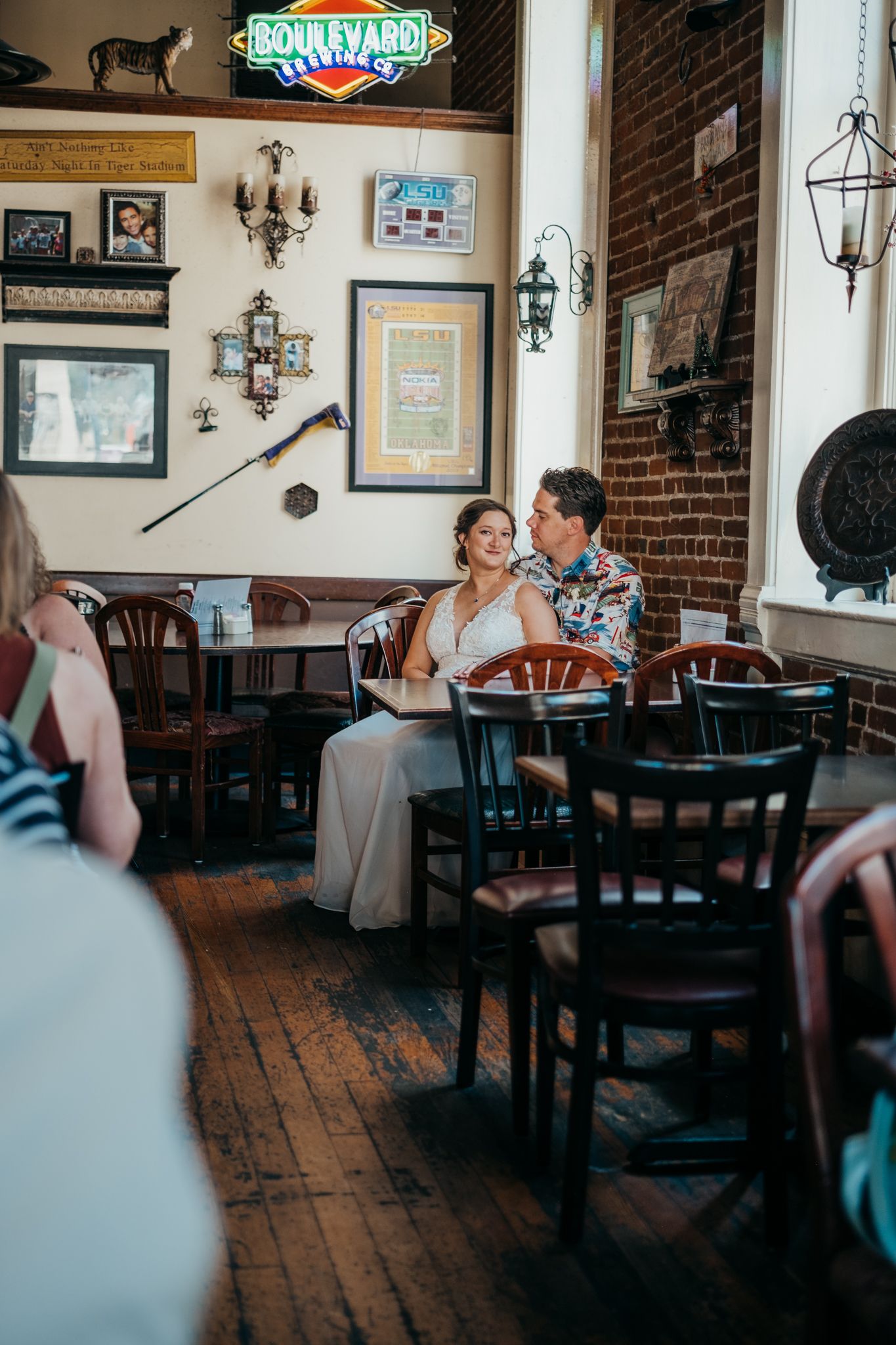 Couple sits at restaurant in downtown Kansas City, Missouri for wedding photography by Tiffany Arnold Photography.
