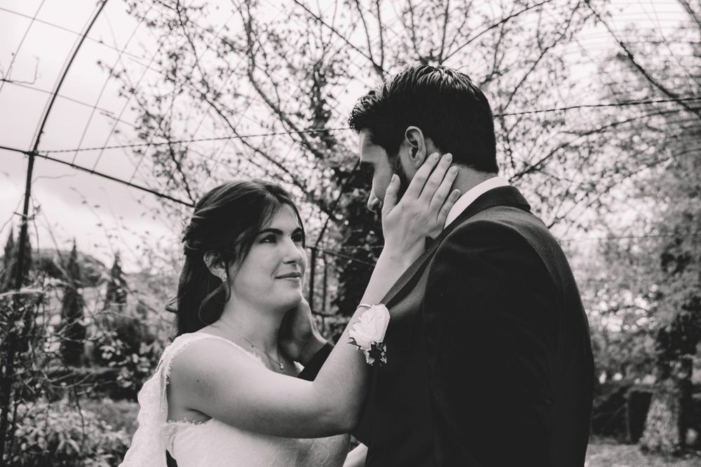 Intimate black and white portrait of newlyweds sharing an emotional moment.
