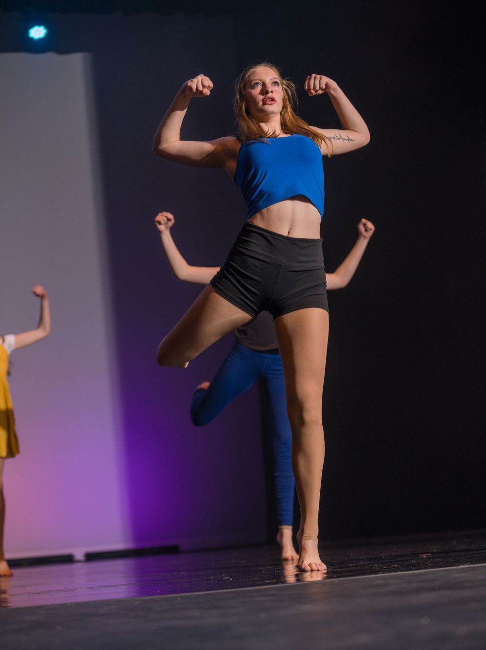 A dancer flexes her arm during the 2023 Metamorphosis dance performance photographed by Sean Openshaw.