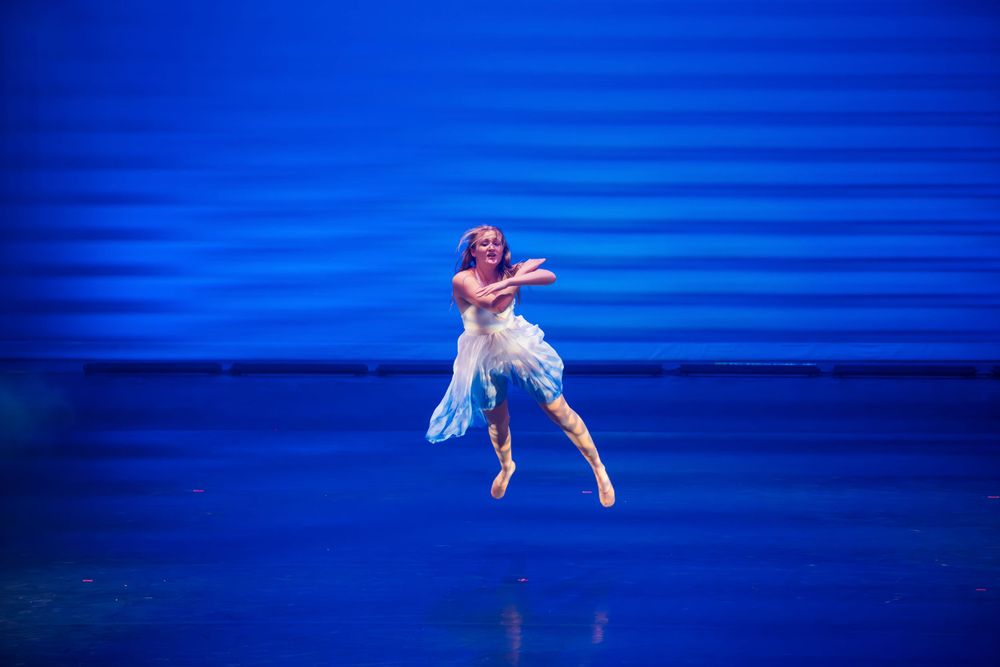 A dancer flies through the air  during the 2023 Metamorphosis dance performance photographed by Sean Openshaw.