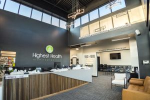 Modern reception area of Higher Health facility with wooden accents and contemporary design.