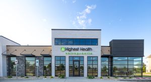 Contemporary commercial building exterior featuring Higher Health signage and glass storefront.