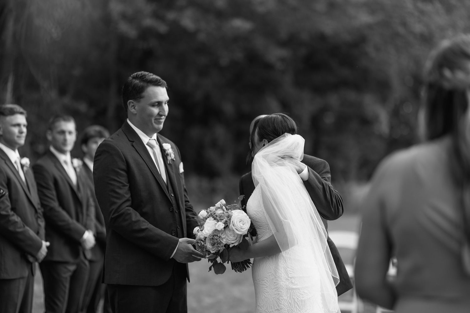 Summer time wedding in Louisiana. Father giving his daughter away to groom.