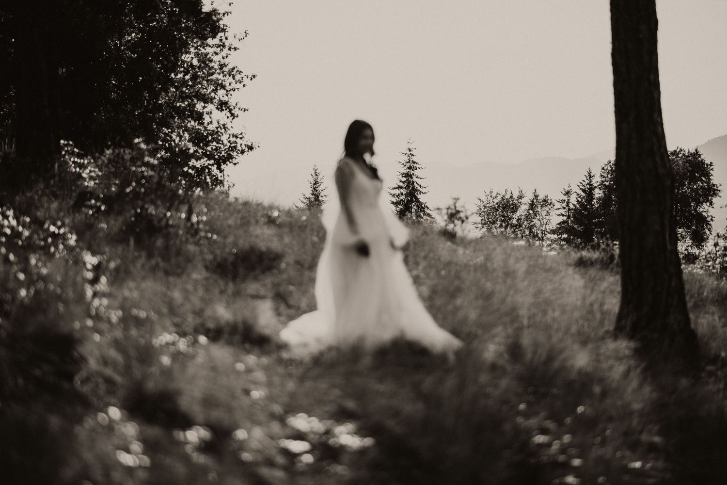 Creative portrait of a woman. Standing in a grass field taken by Okanagan phorographer