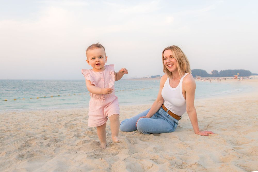 beach photoshoot with toddler in pastel pink