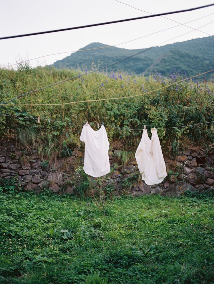 White linen hanging on a countryside washing line.