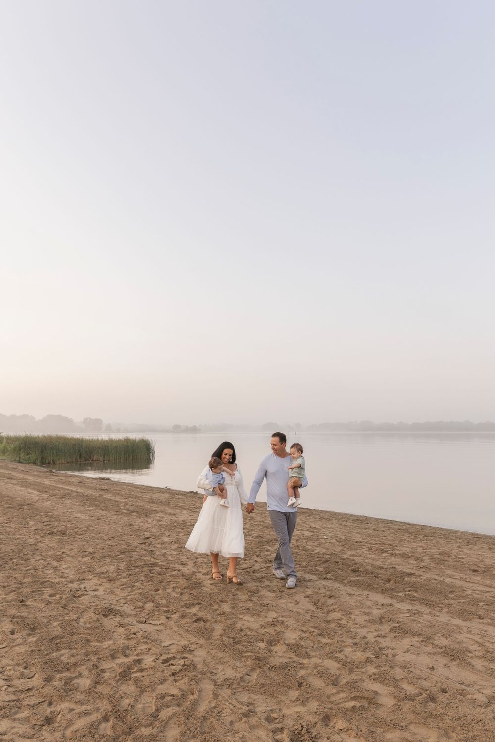 family of four walking along the beach at Stoney Creek at sunrise