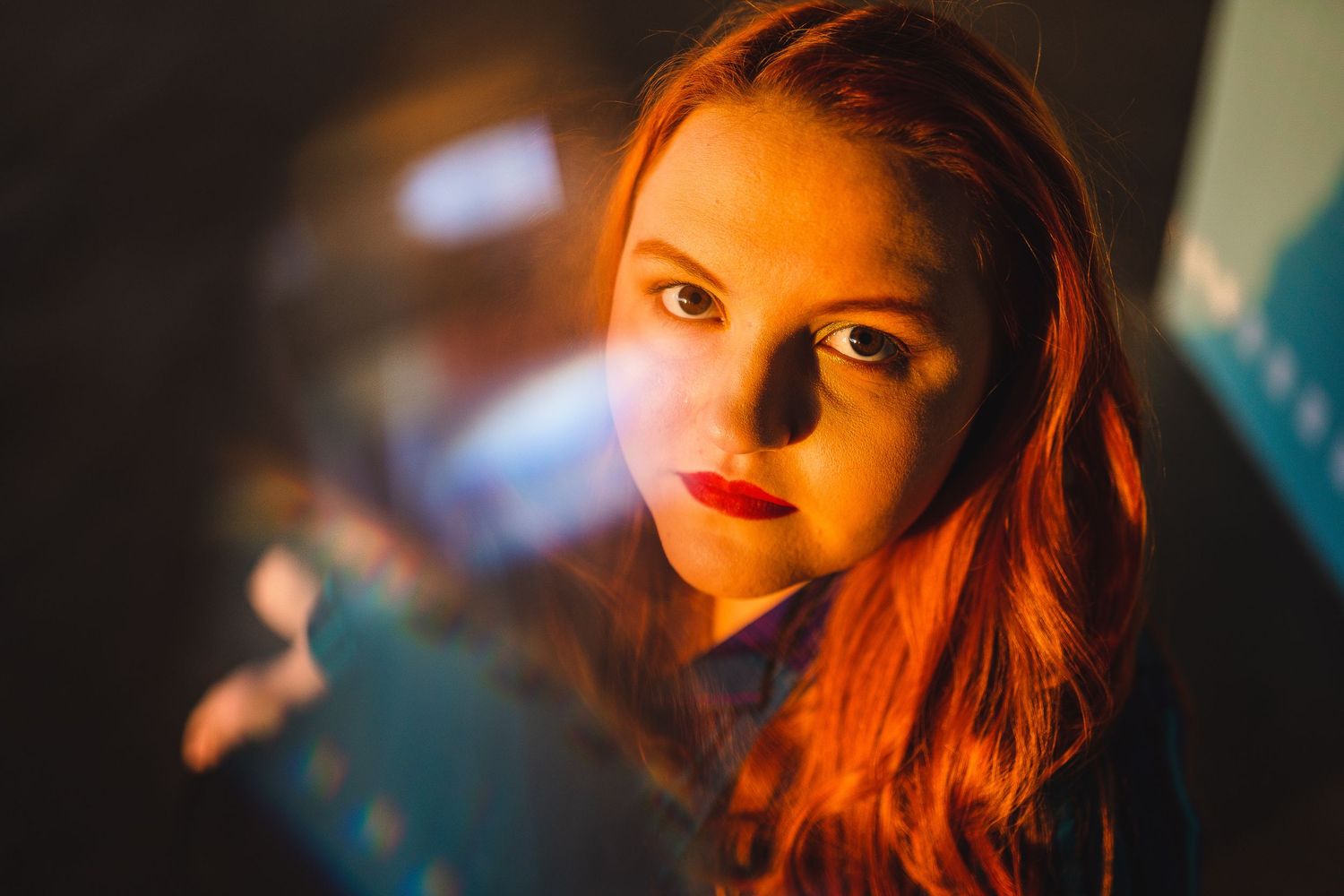 Dramatic portrait with moody lighting and colorful background.