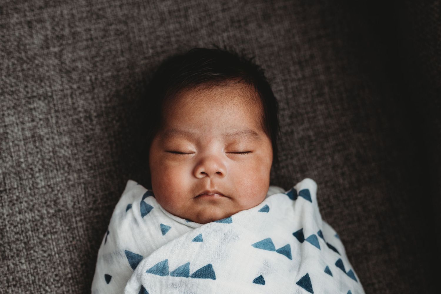 Baby boy swaddled and contentedly sleeping