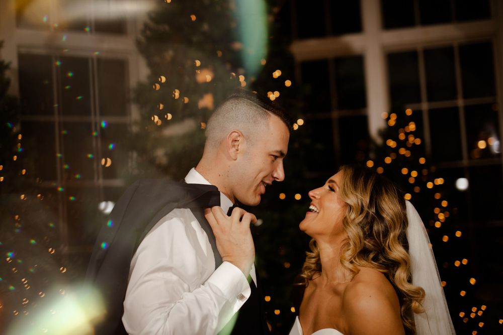 A romantic sparkler-lit wedding moment creates magical ambiance during an evening celebration.