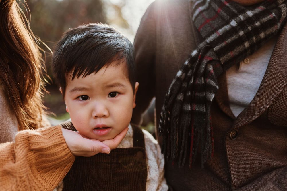 Close up portrait in warm autumn lighting with brown scarf and sweater details.