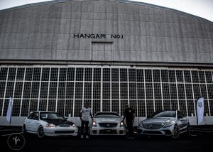 Large industrial hangar building with glass windows and modern architecture.