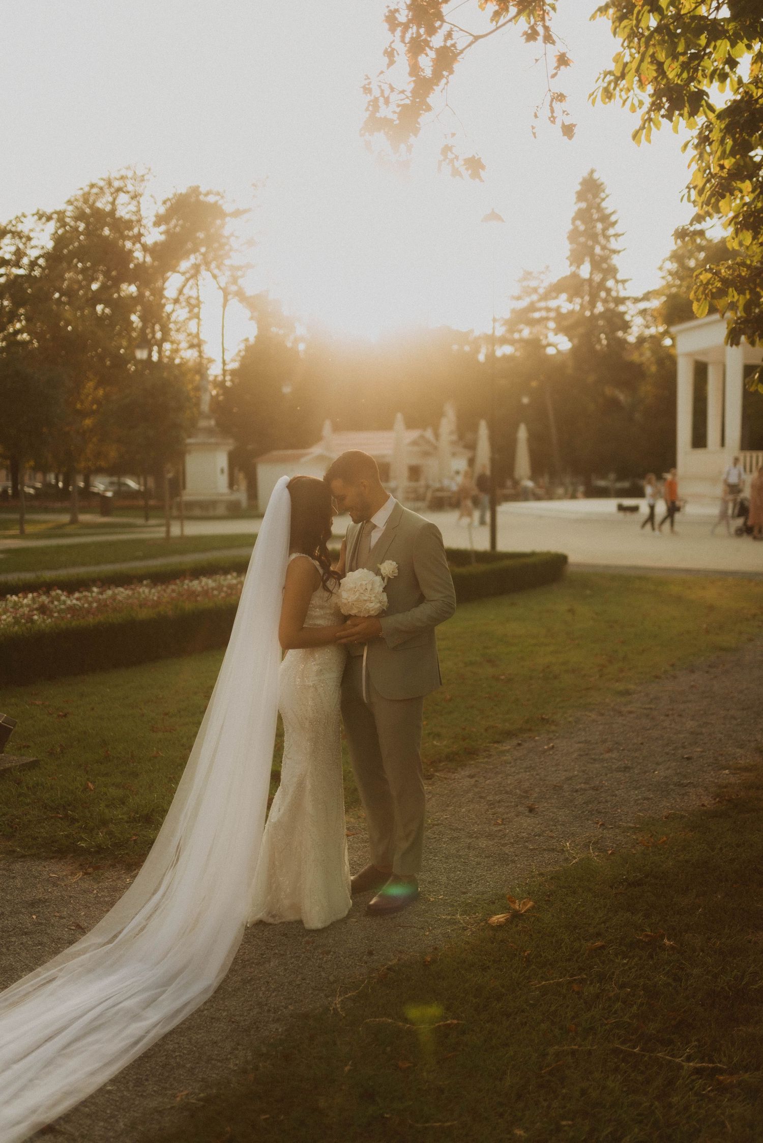 A romantic wedding moment captured at golden hour in an elegant garden setting.