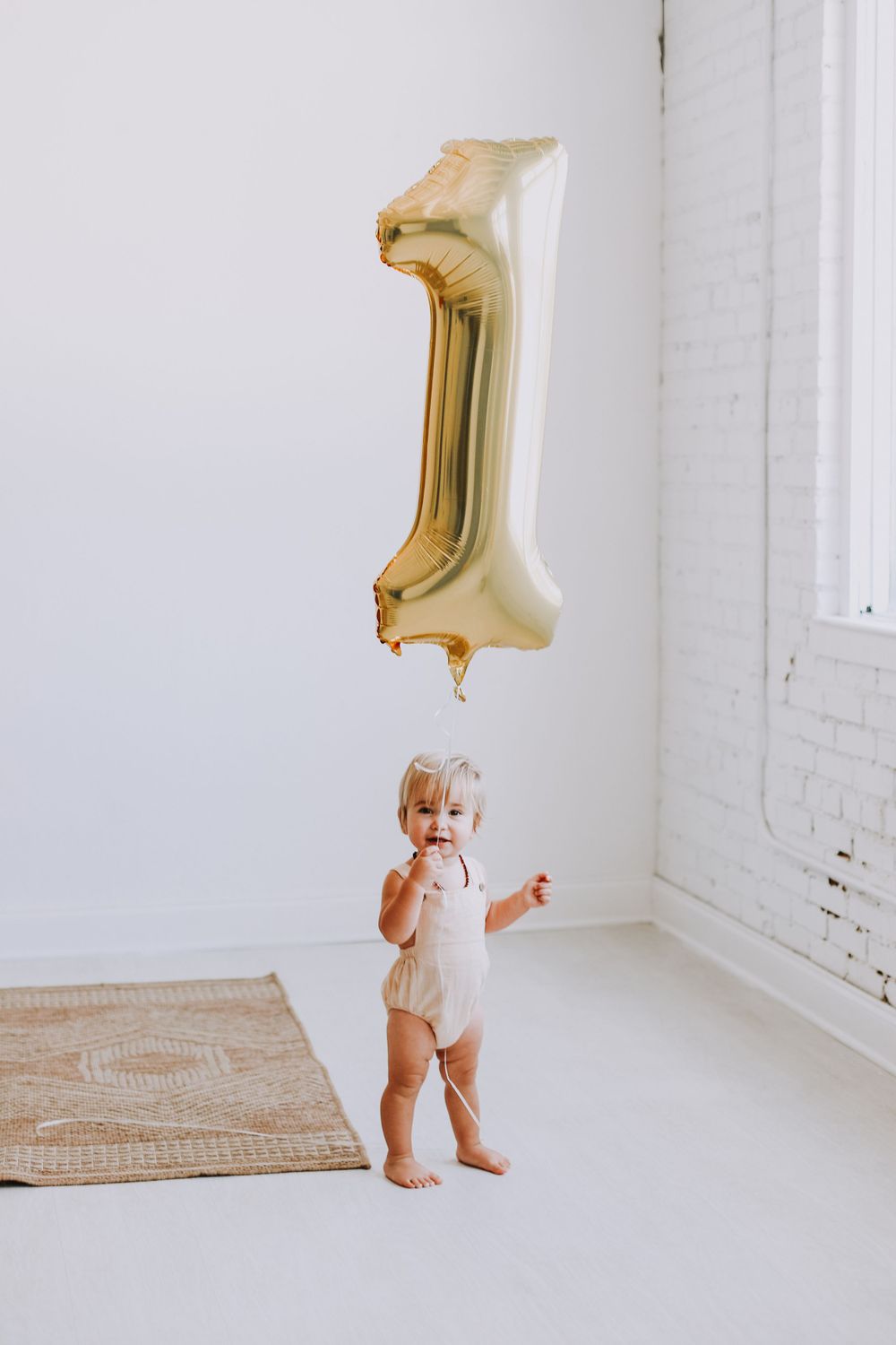 First birthday kids photo shoot with balloon in photo studio