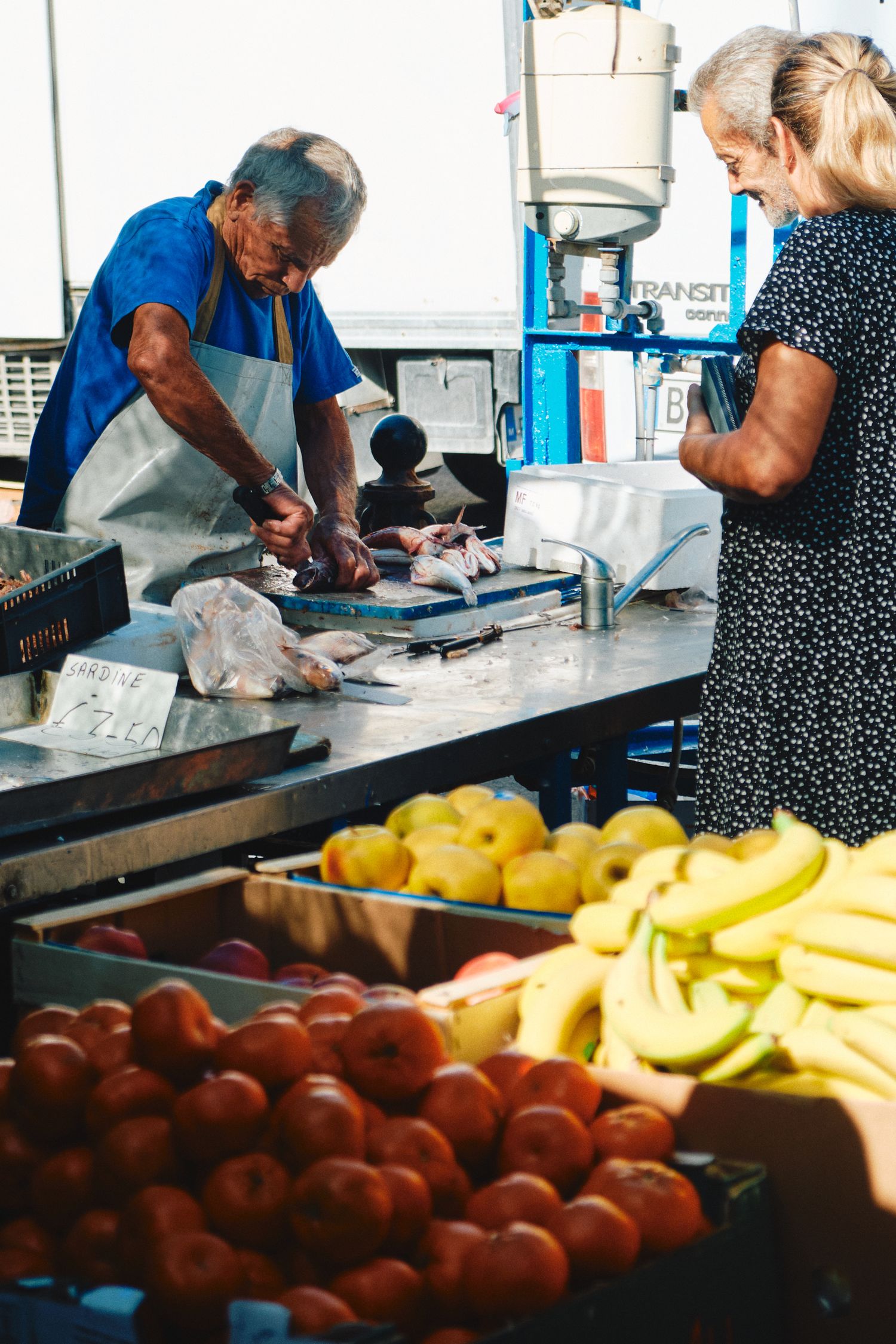 Fresh produce market stall with colorful fruits and vegetables on display.