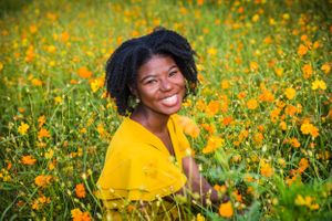 Portrait series in a vibrant field of yellow wildflowers with bright yellow clothing against natural background.