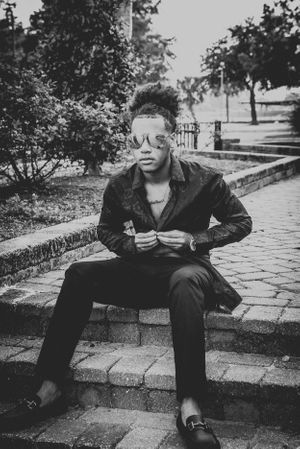 Artistic black and white photo series showing figure seated on stone steps in urban setting.