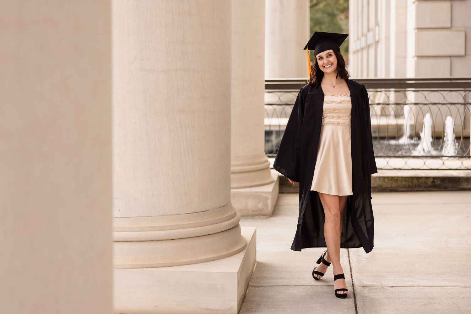 Architectural columns create an elegant backdrop for graduation photos.