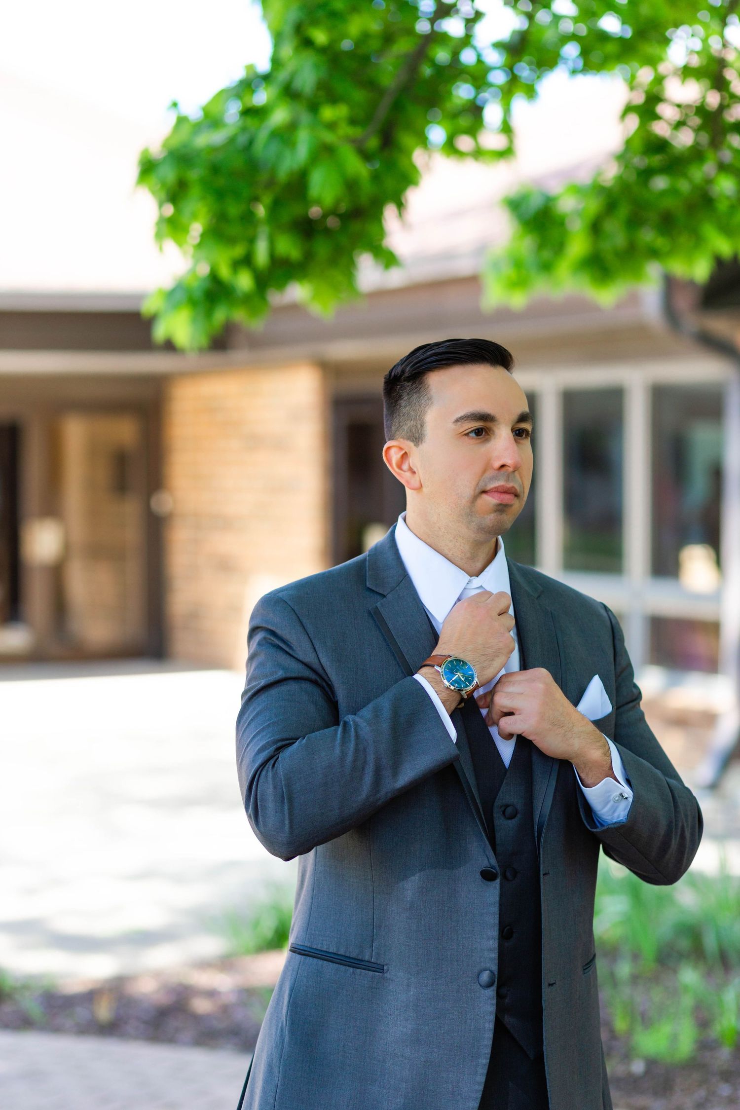groom adjusts his tie for a cleveland, ohio wedding
