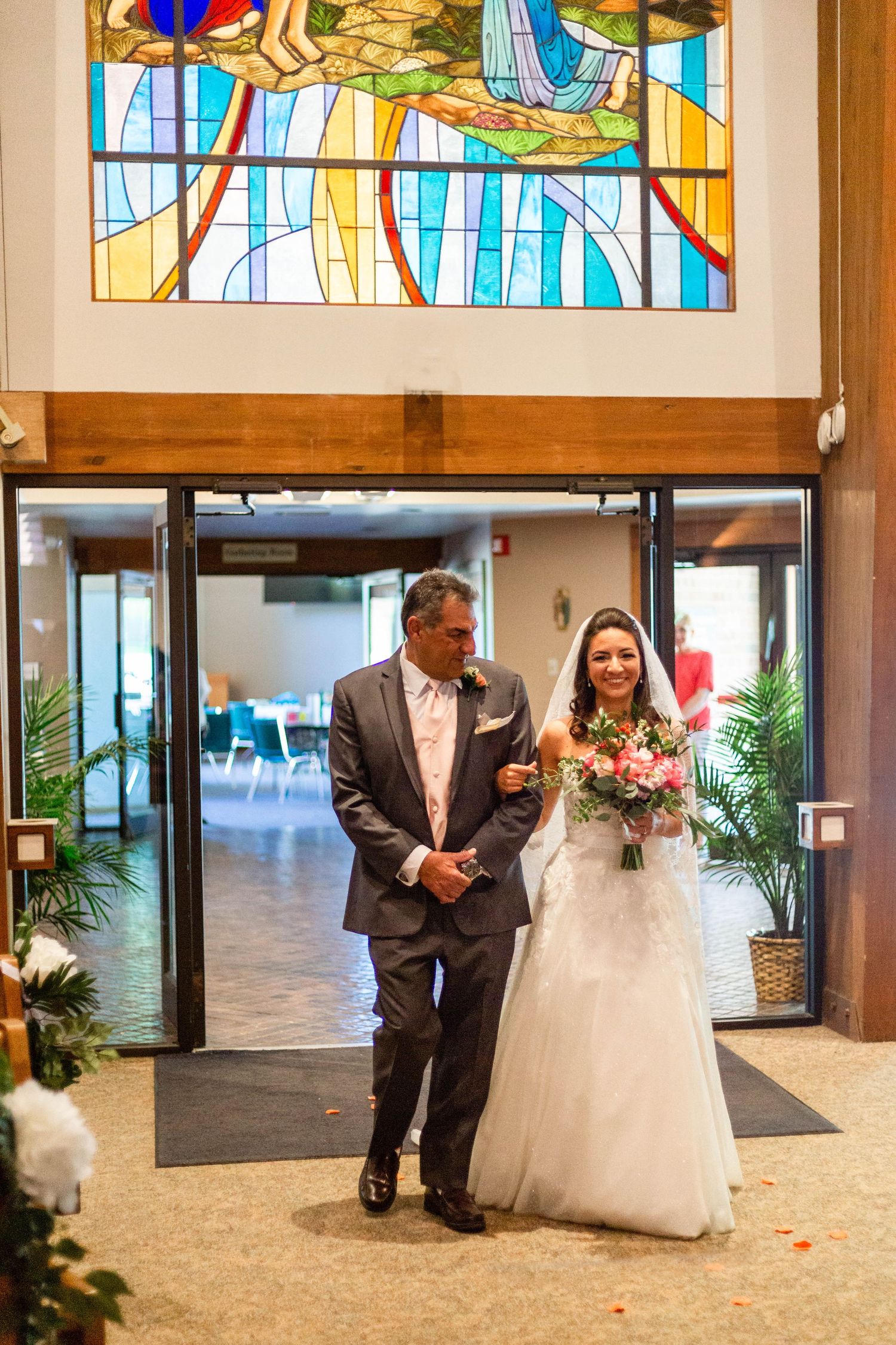 bride and her dad walk down the aisle