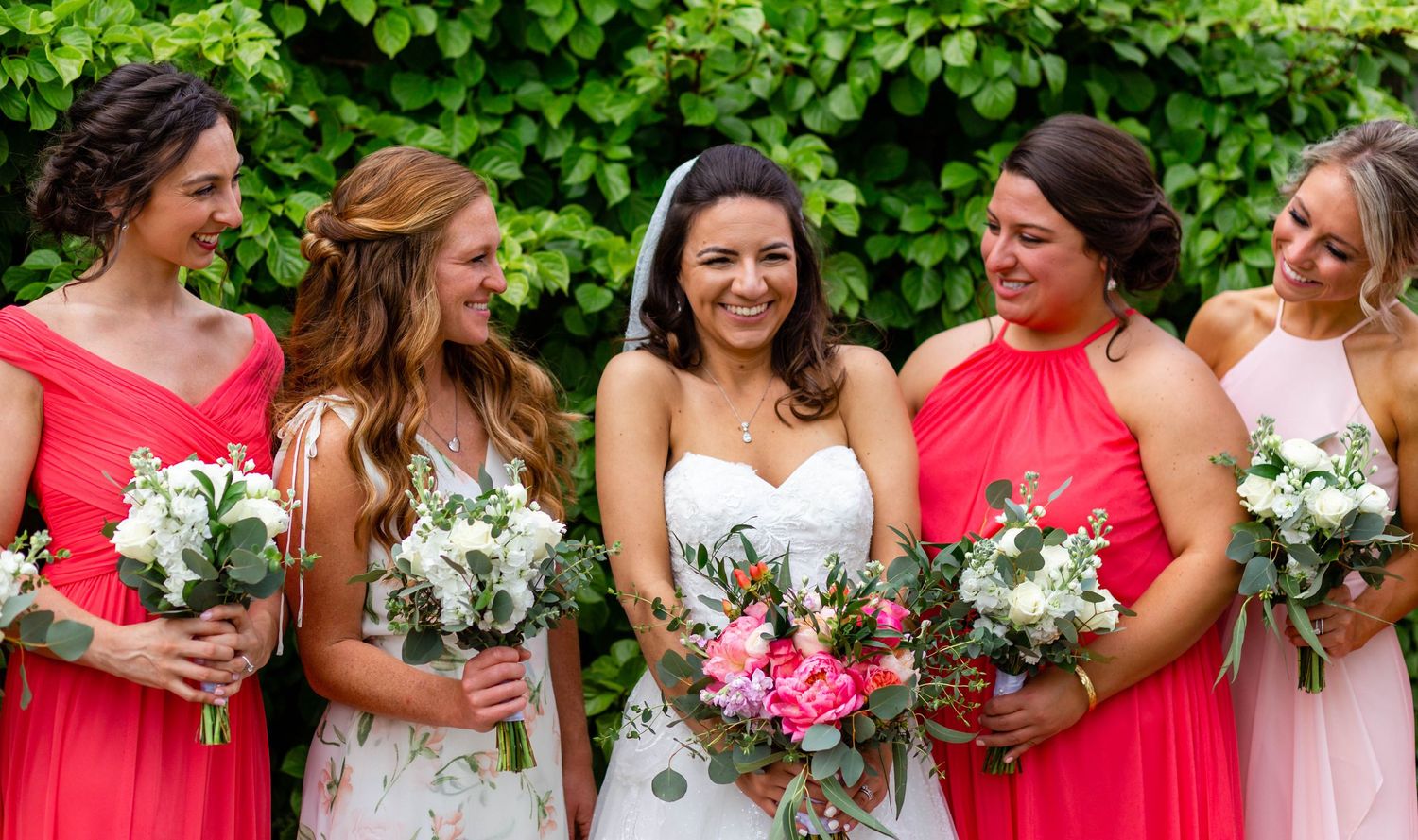 a bride laughs with her bridesmaids