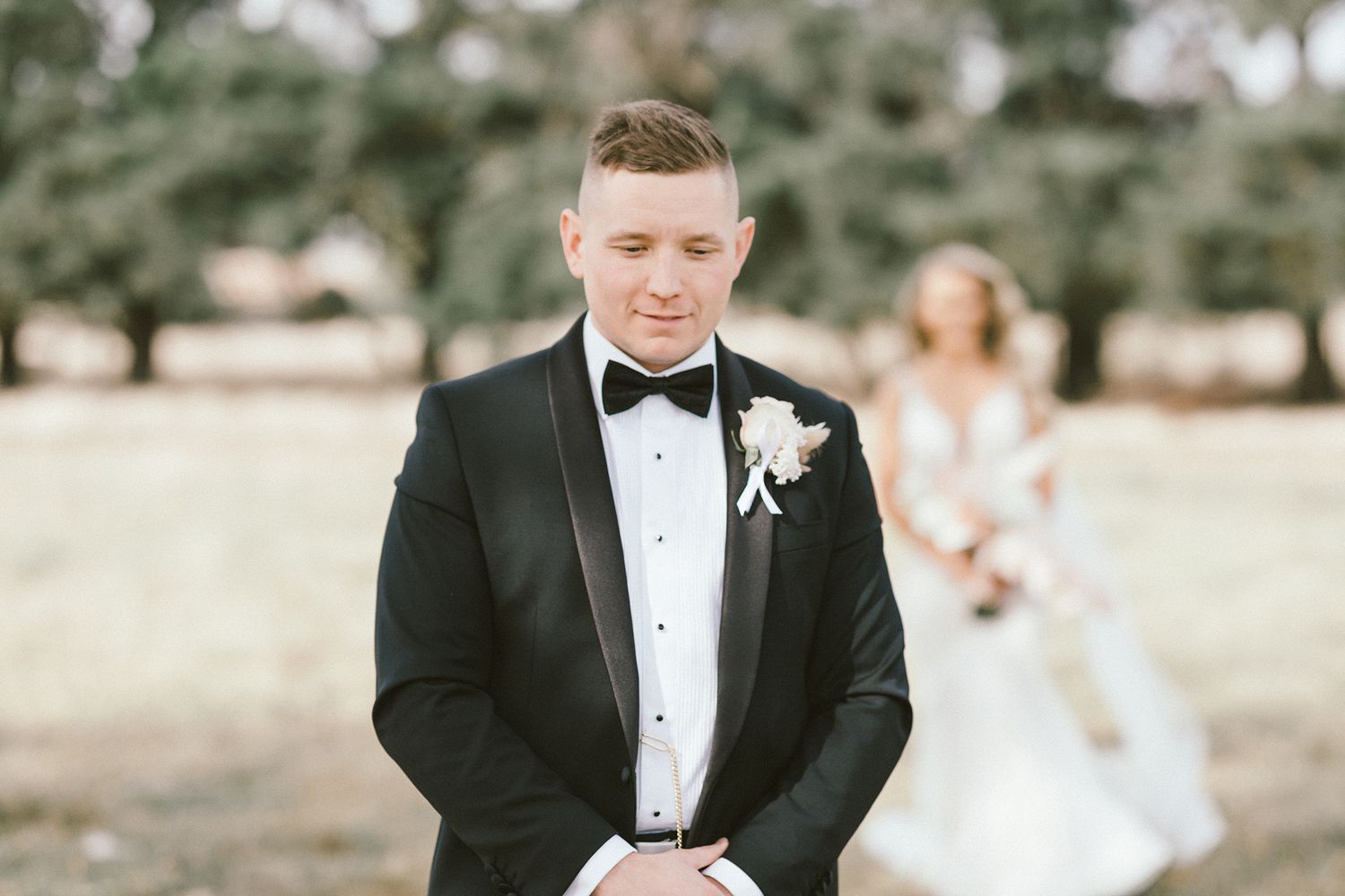 An elegant wedding portrait in a natural Australian landscape setting.