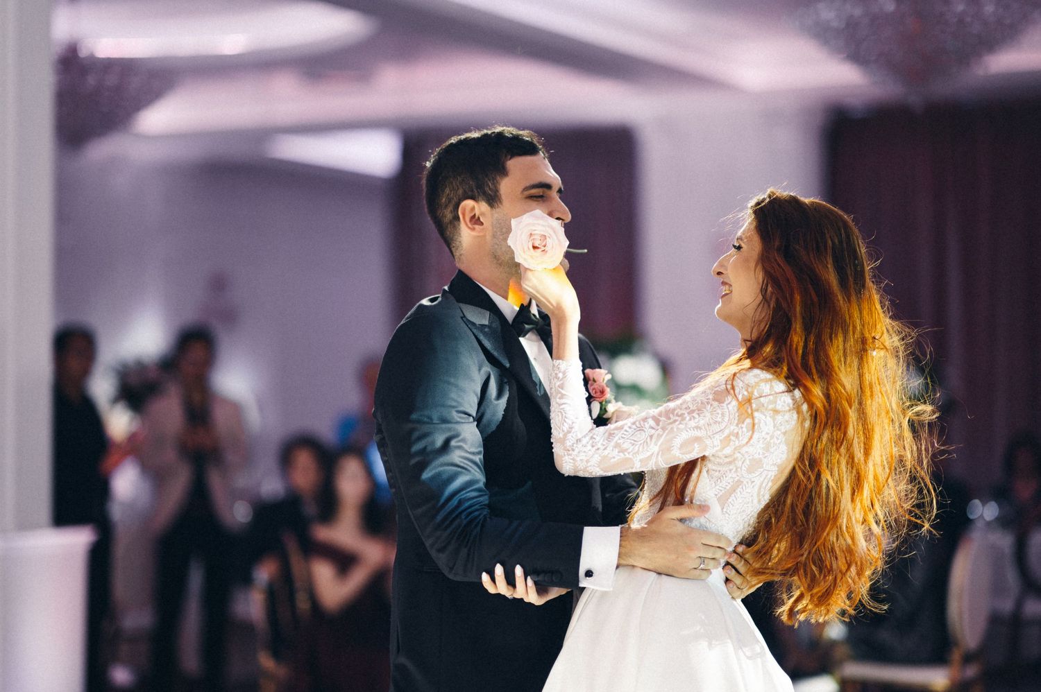 A couple shares an intimate dance moment at their wedding celebration.