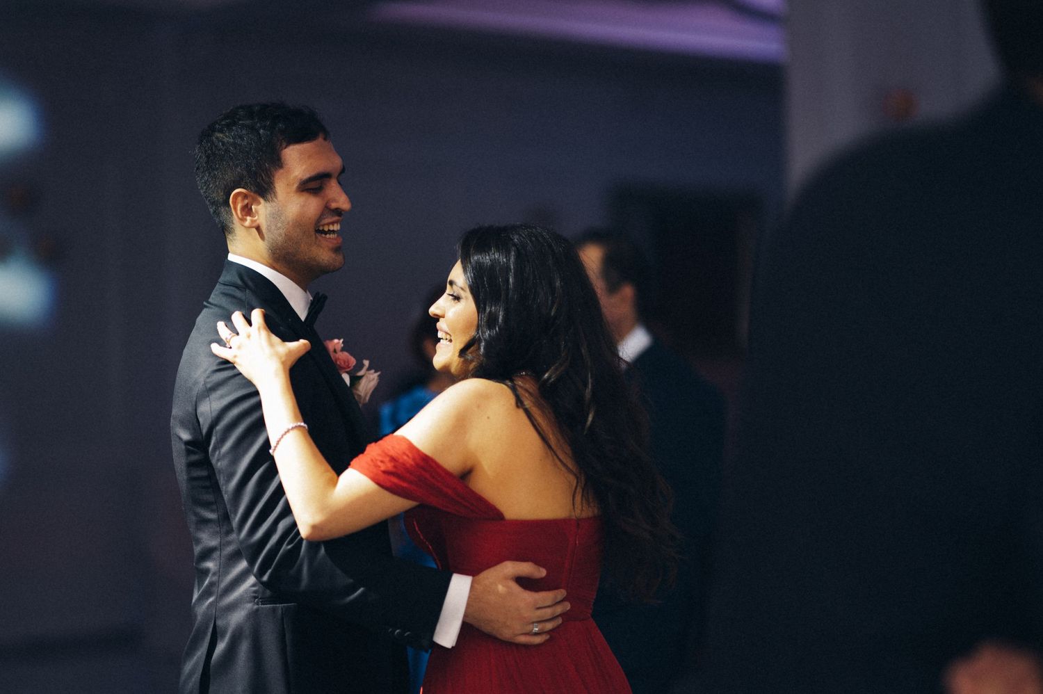 A couple dances together during an evening celebration event.
