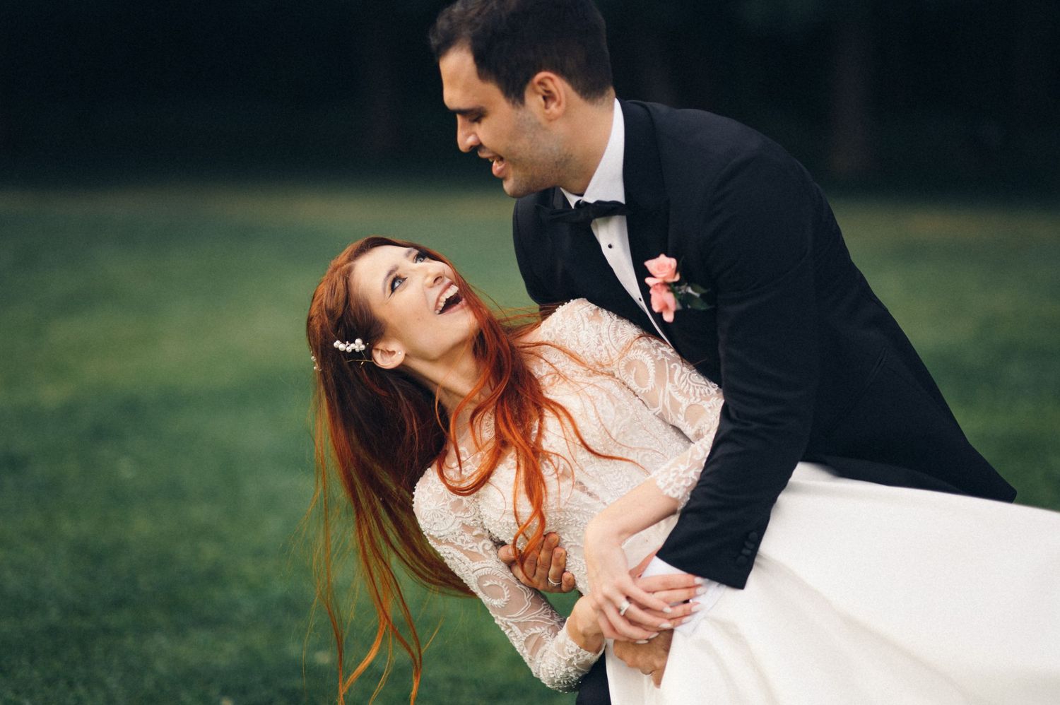 A romantic wedding dance moment captured in an outdoor setting with dramatic pose.