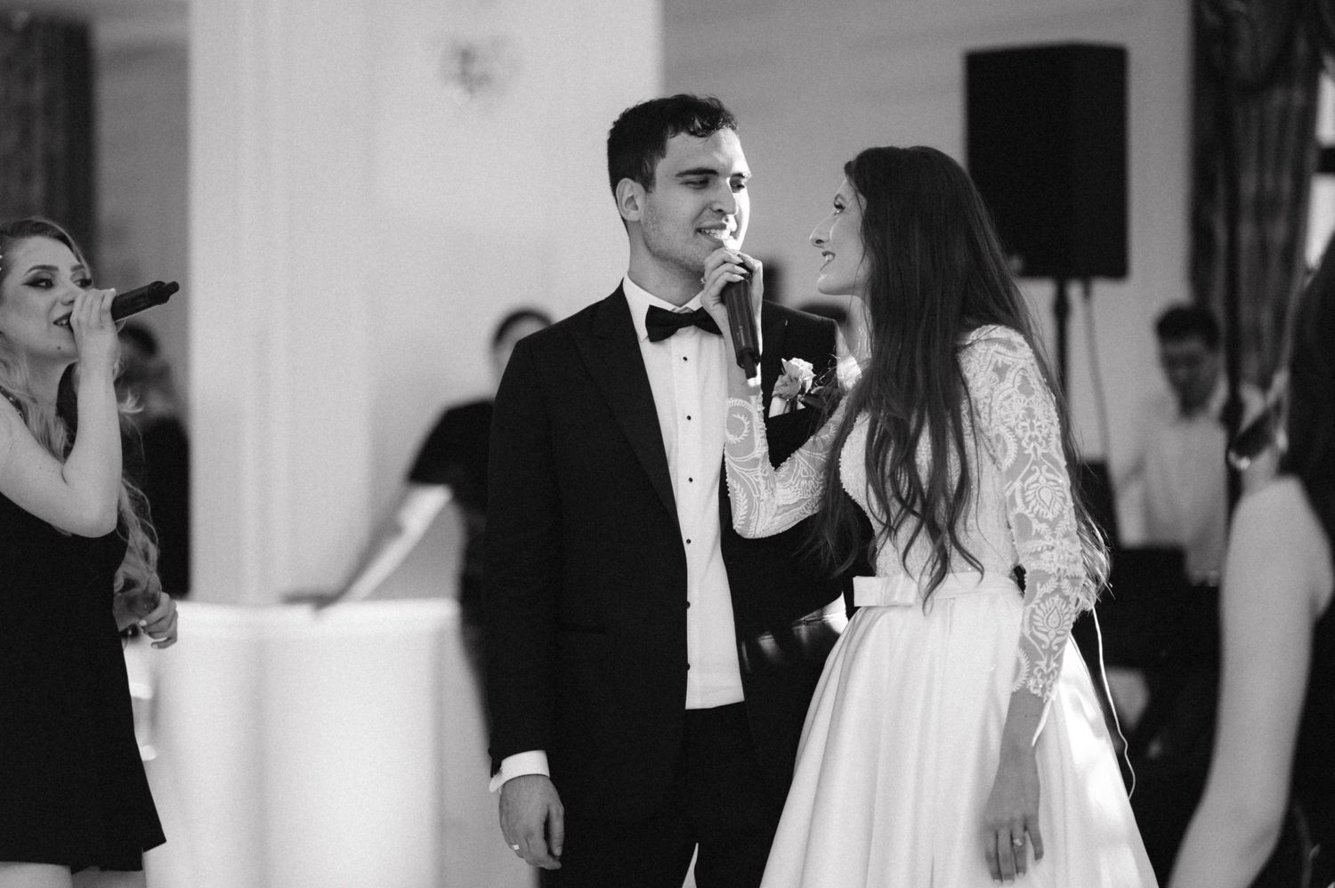 Black and white photo showing dancing and entertainment at formal celebration.