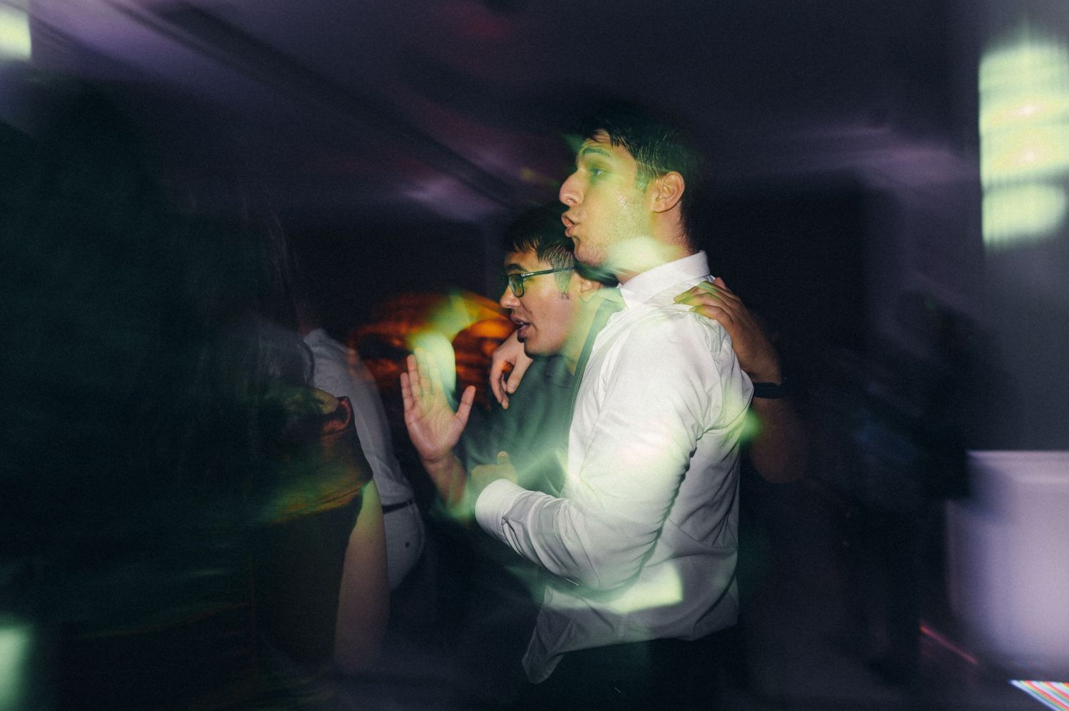 Motion-blurred photo of guests dancing at a nighttime celebration.