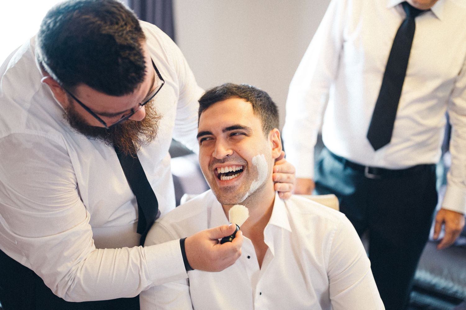 Candid moment of grooming preparation with laughter and smiles.