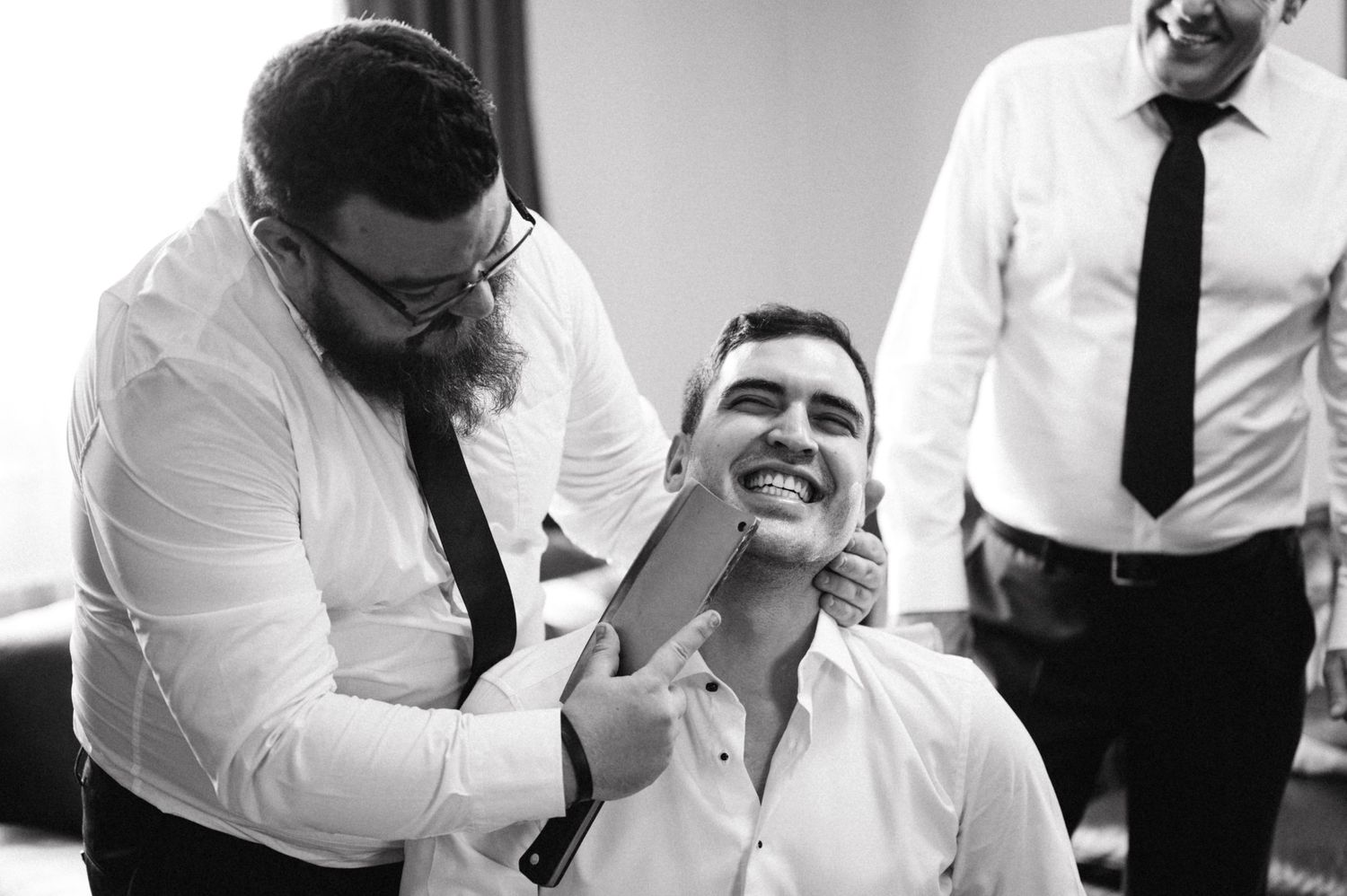 Black and white image of grooming preparations with laughter.
